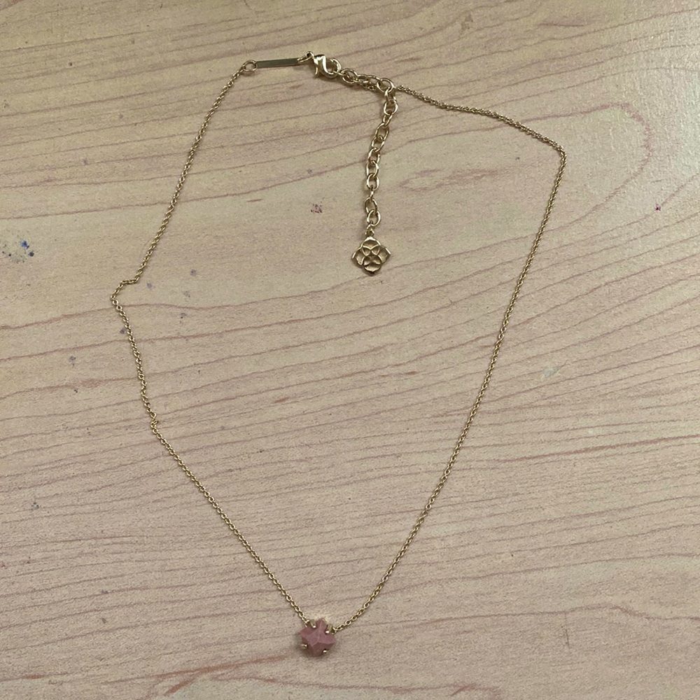 Kendra Scott gold necklace with light pink square stone